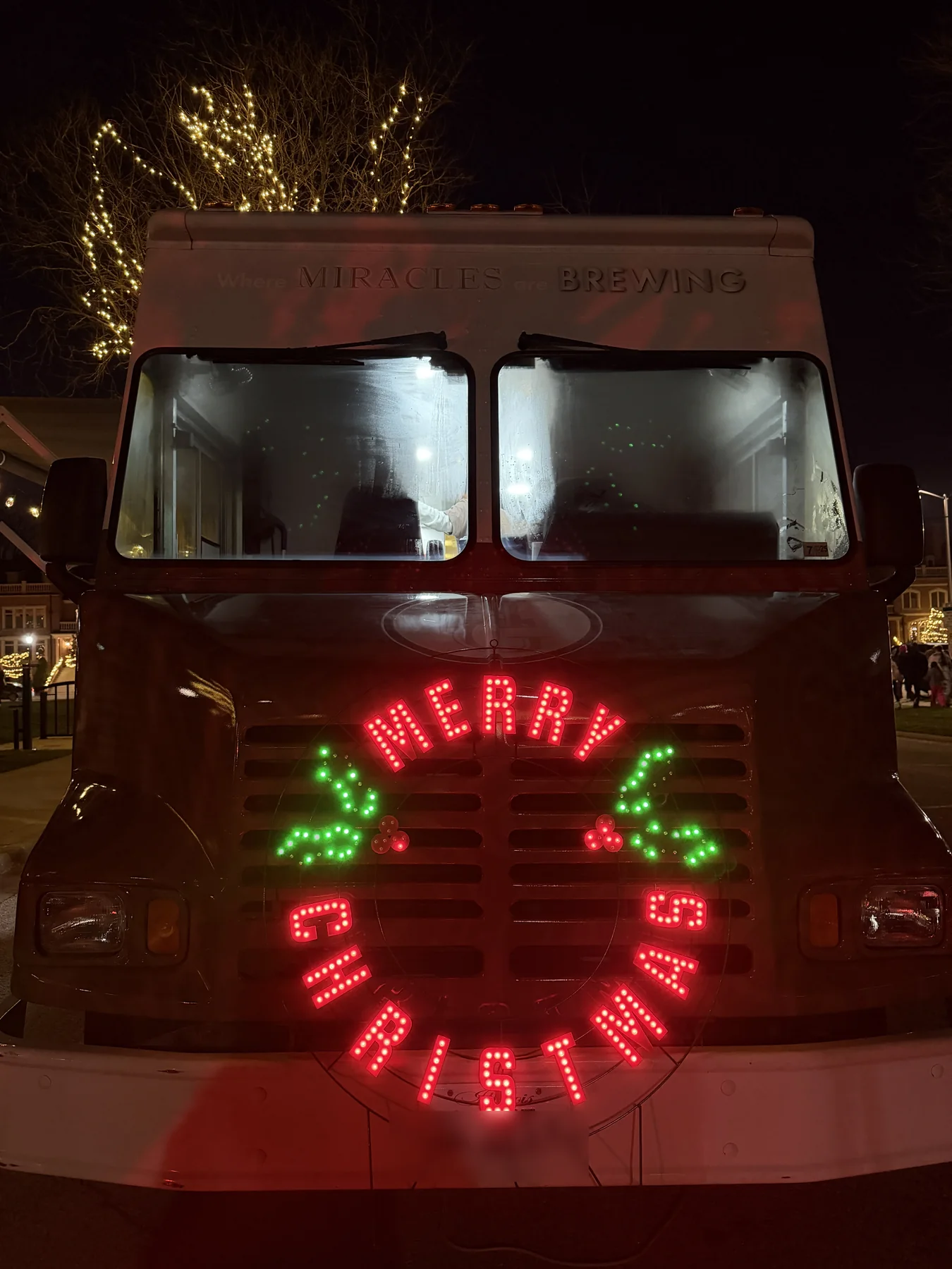 The front of the Holy Grounds truck decorated with Merry Christmas lights